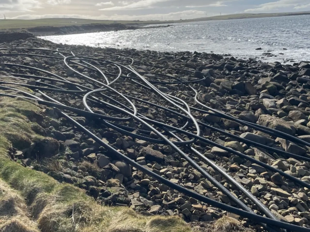 Black plastic feed pipe used on fish farms with automatice feeders